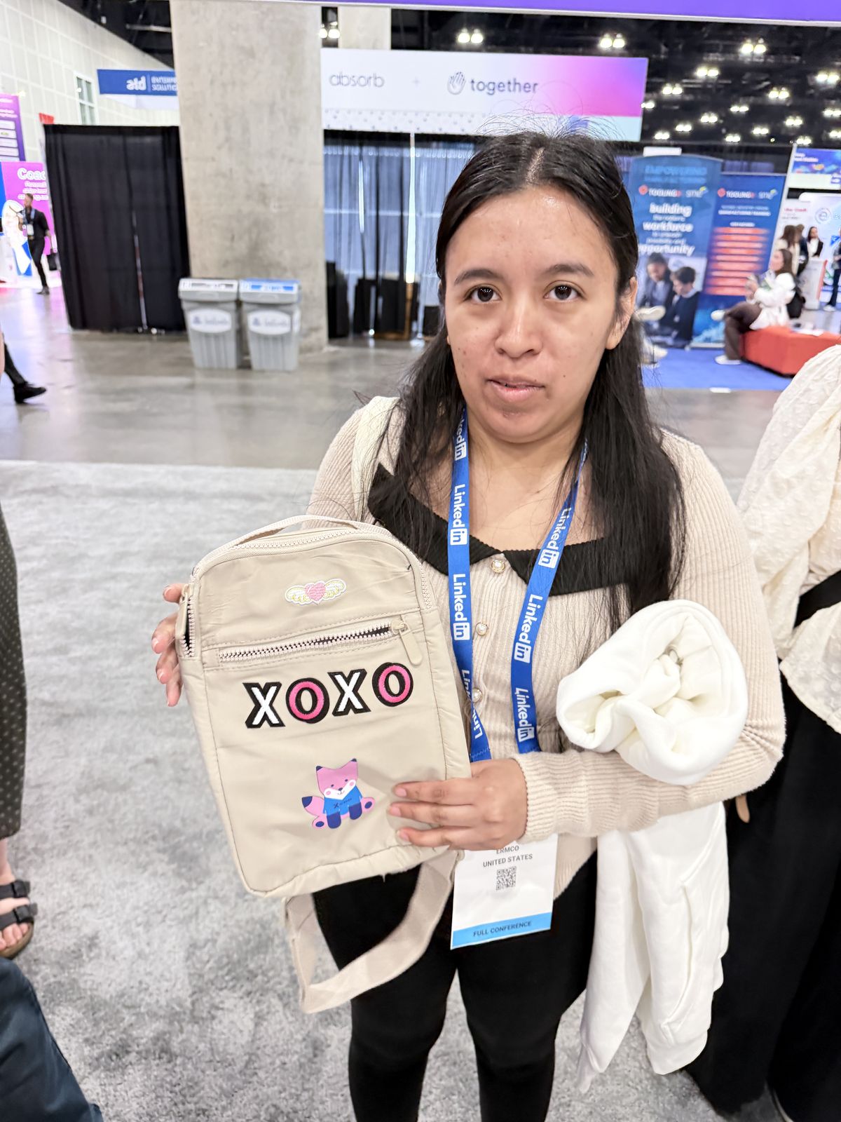 Guest showing off her bag customized with pink XOXO chenille patches at our station